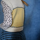 Person wearing a colorful sweater with a patterned design on a blue background