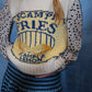 Close-up of a person wearing a knitted sweater with text and graphics on a blue background