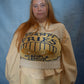 Person wearing a beige sweater with text on a blue background